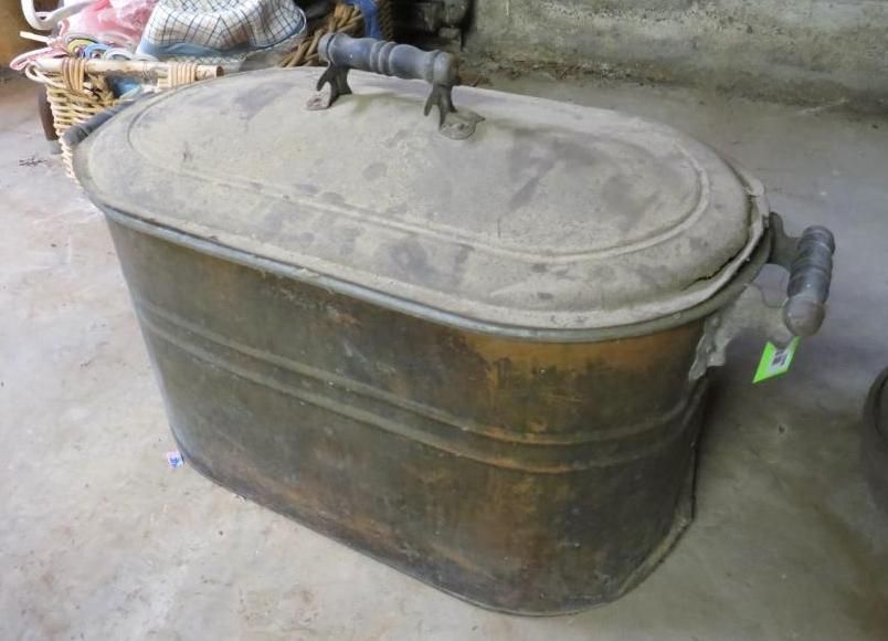 Copper tub with lid and wooden handles, in an indoor setting.