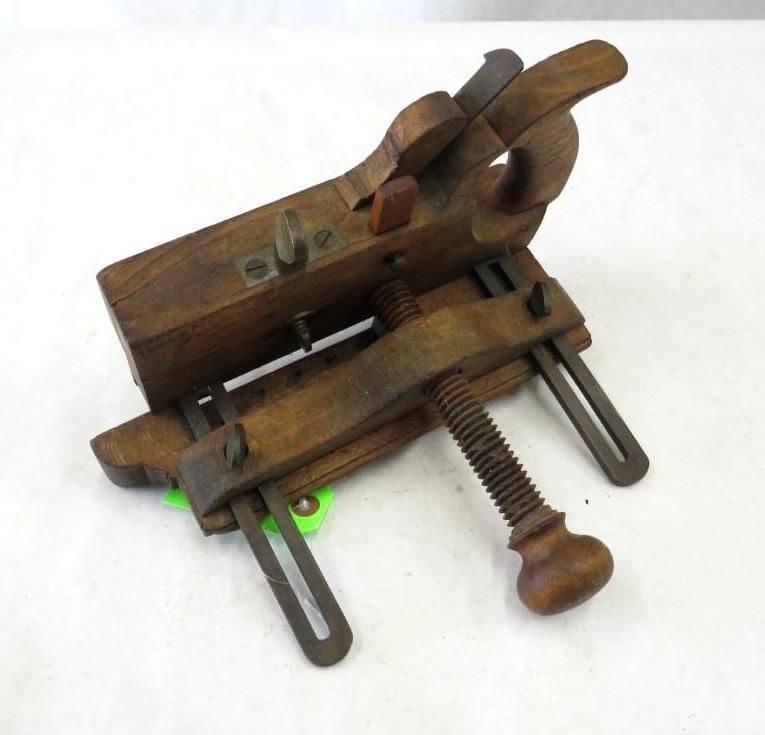 Wooden woodworking tool with a threaded adjustment screw.
