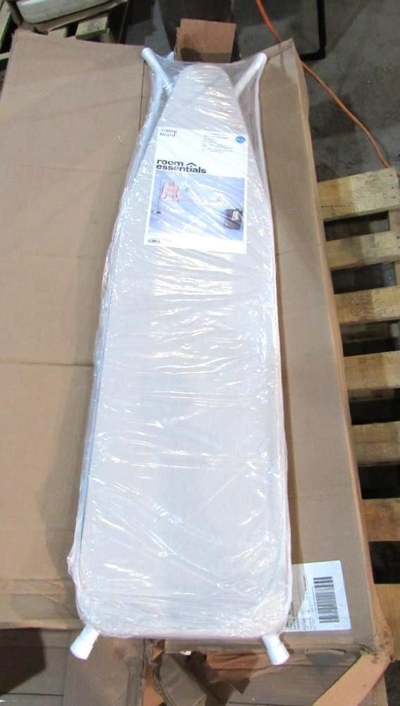 Ironing board wrapped in plastic, on cardboard box and wooden pallet.