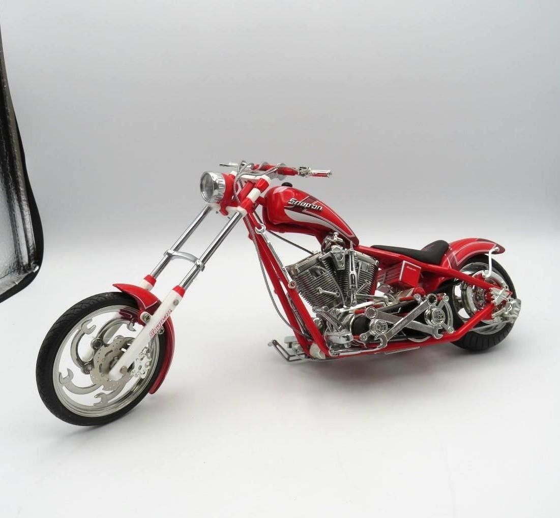 Red and chrome chopper motorcycle model on a white background.