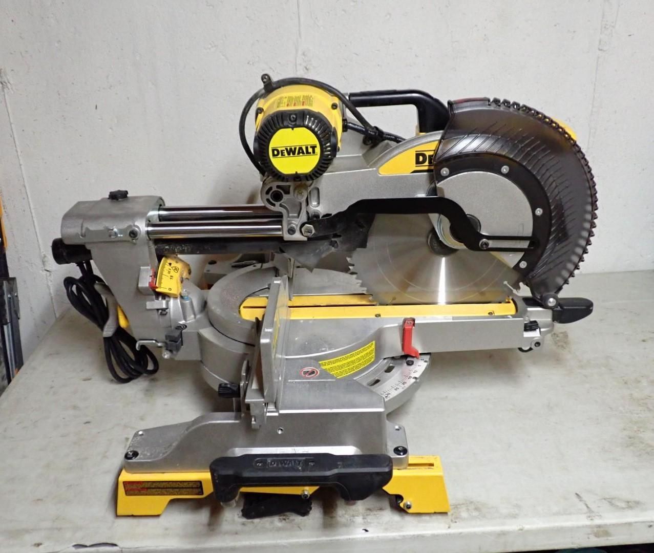 Yellow and silver DeWalt miter saw on a workbench.