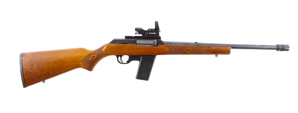 Rifle with a wooden stock, black magazine, and optic sight.