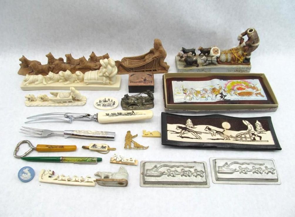 Collection of small figurines and decorative items, with themes including dog sled teams and Native American scenes.