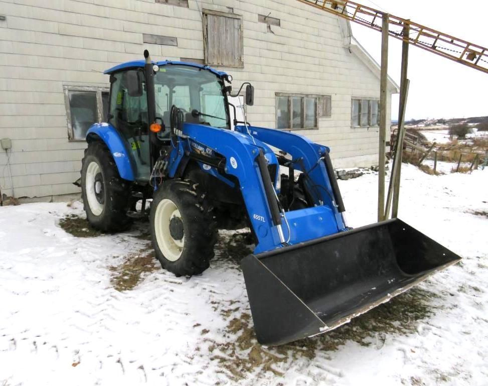 Blue tractor with front loader.