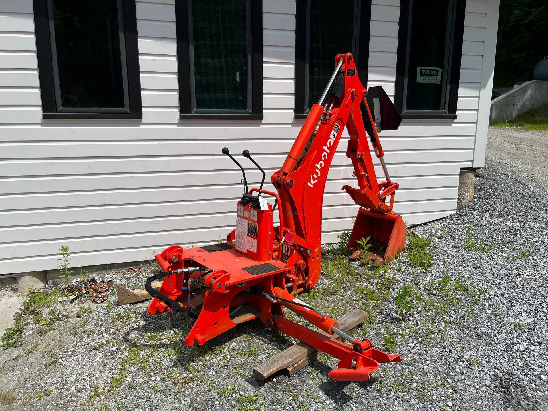 Red Kubota backhoe.