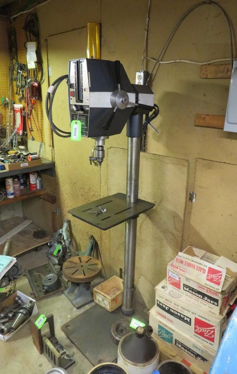Black and silver drill press machine.