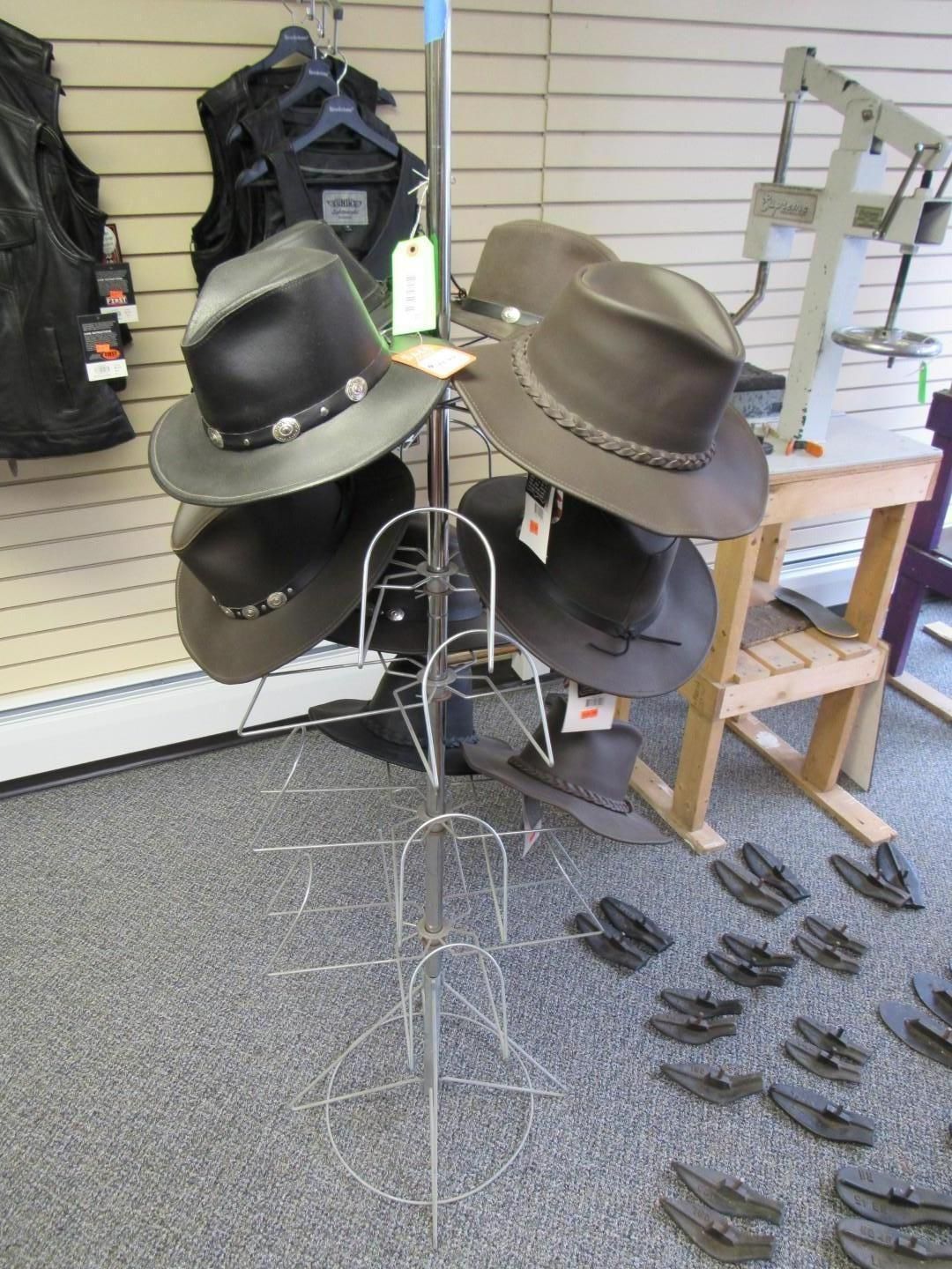 Hats displayed on a wire rack in a retail store.