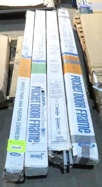 Four boxed pocket door frames stacked on a pallet.