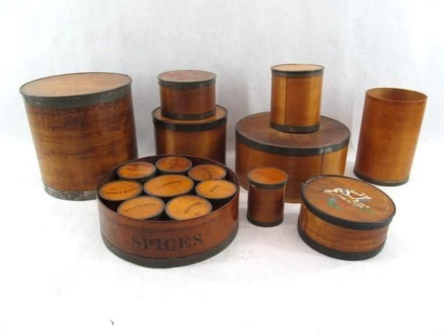 Collection of various antique wooden spice containers of different shapes and sizes.