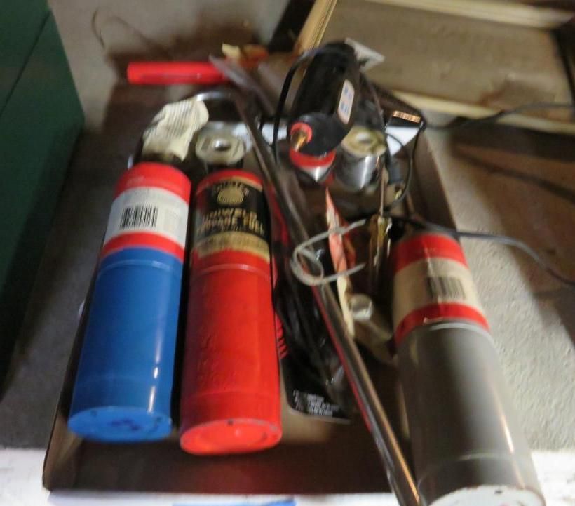 A tray with blue, red, and gray cylindrical objects, along with tools and wires.