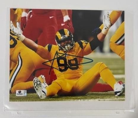 Football player in yellow uniform celebrating on the field, arms raised, number 99 visible. Signed Photo.