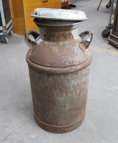 Metal milk can with a lid and handles.