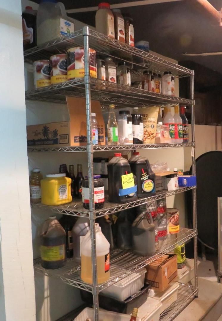 Metal shelving unit filled with various food items in a pantry.