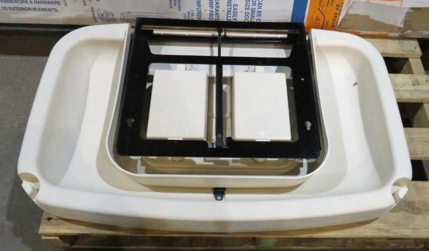 White plastic pet carrier base with black metal frame and two cream-colored containers.