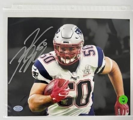 Football player, #50, running with the ball. Signed photo in Patriots uniform.