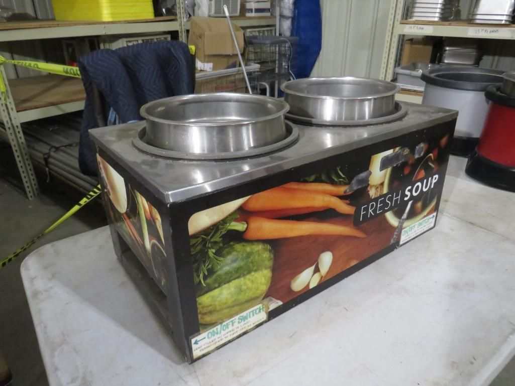 A commercial two-well soup warmer on a table with a