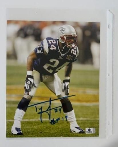 New England Patriots football player signed photo, wearing #24, on the field.