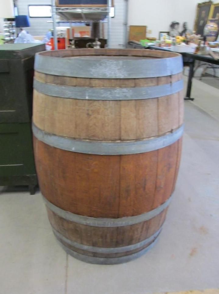 Wooden barrel with metal bands in a room.