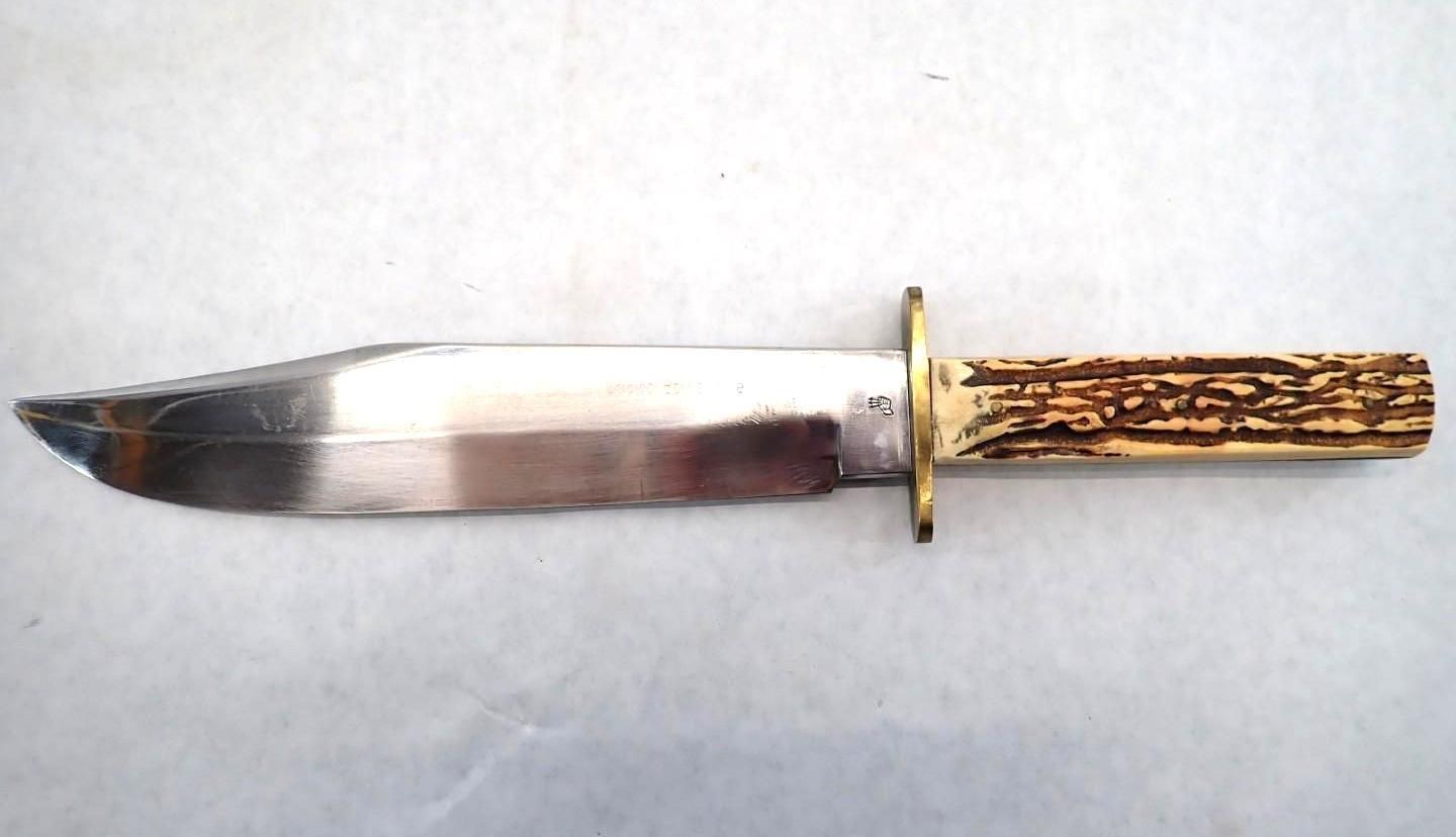 A dagger with a silver blade, gold guard, and ornate amber-colored handle on a white background