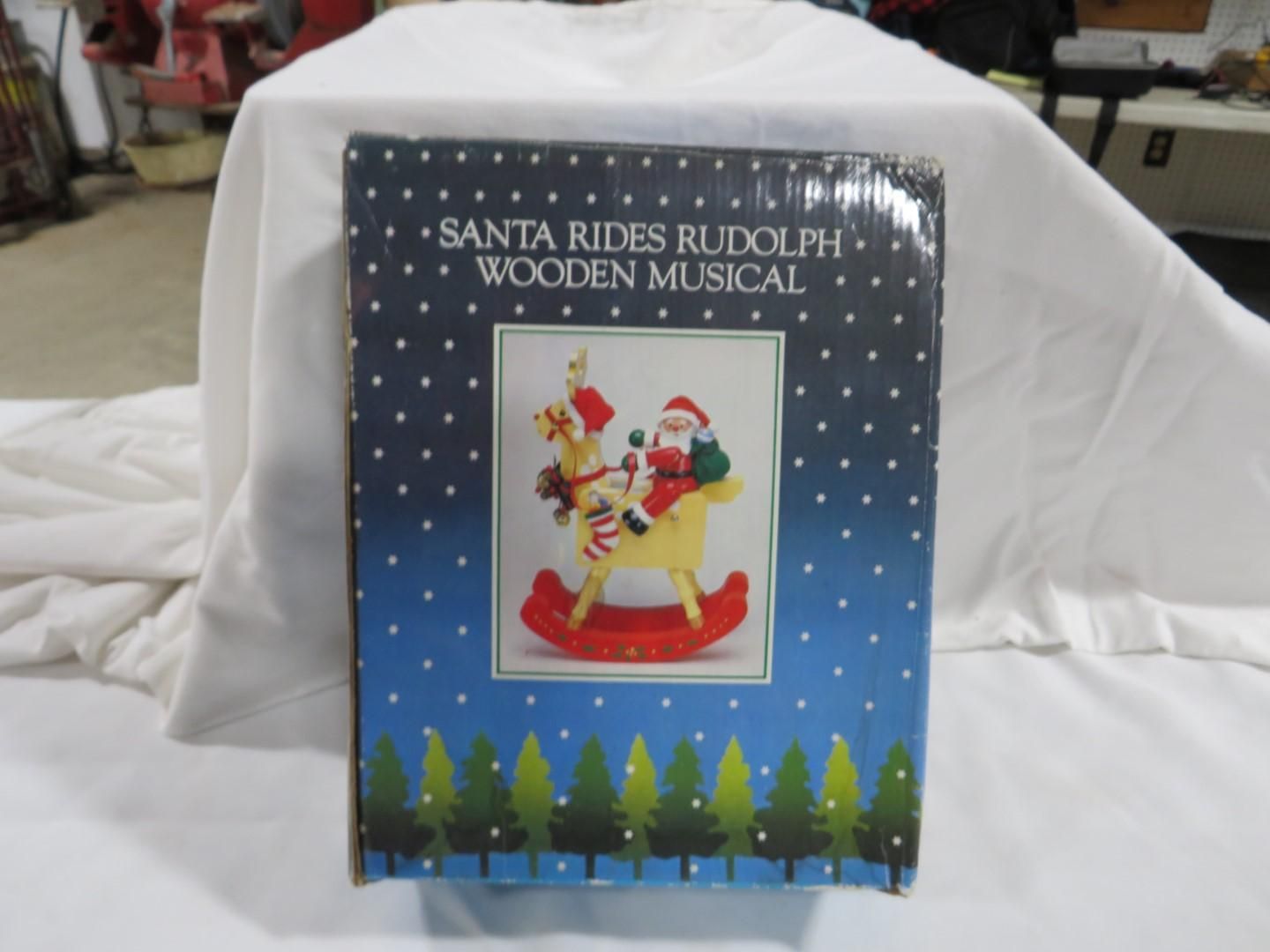 Box with a musical wooden Santa on a rocking Rudolph decoration.