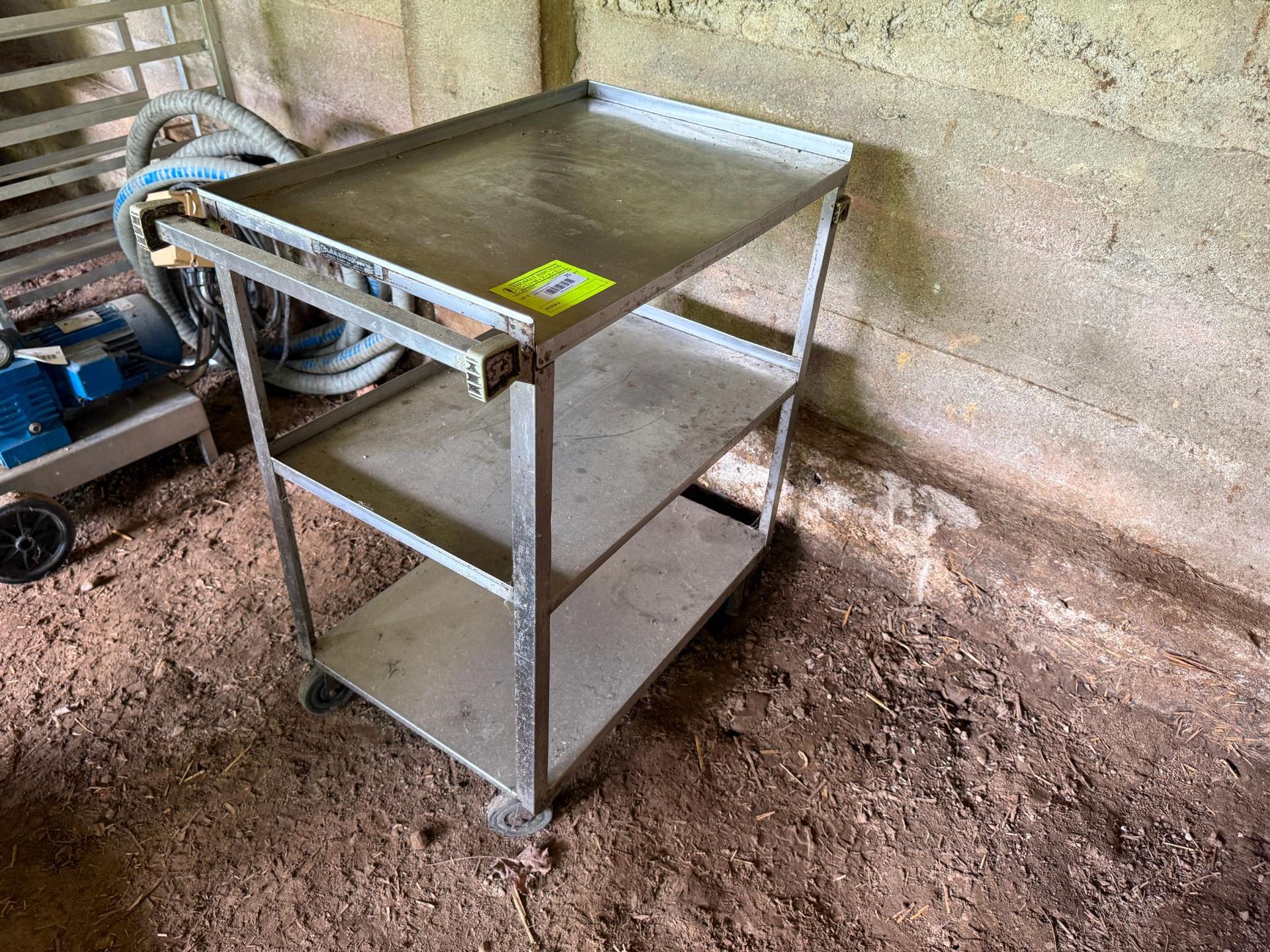 Stainless steel utility cart with three shelves.