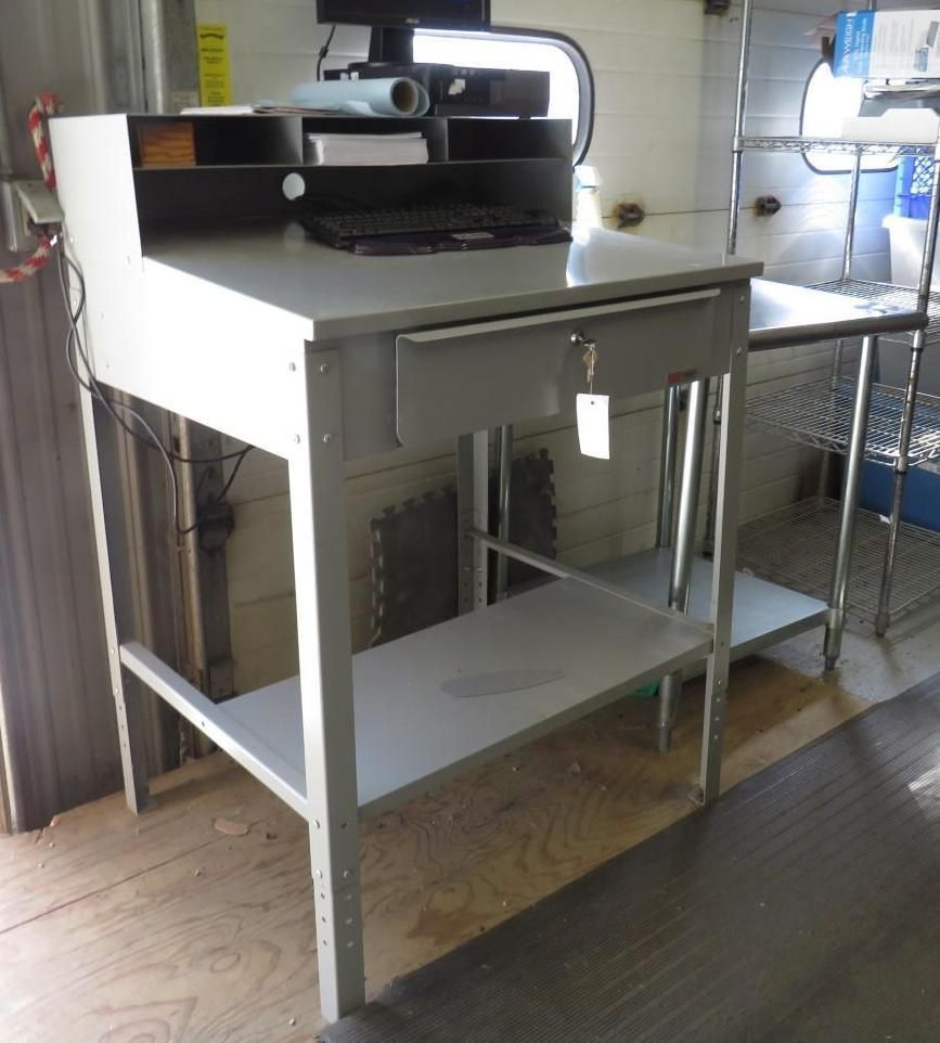 Gray metal workstation with drawer, keyboard, monitor, and shelf.
