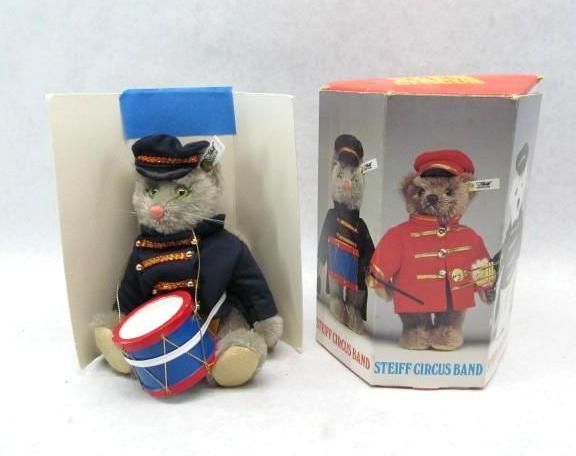 Stuffed cat drummer and Steiff bear in band uniform toys, with boxes.