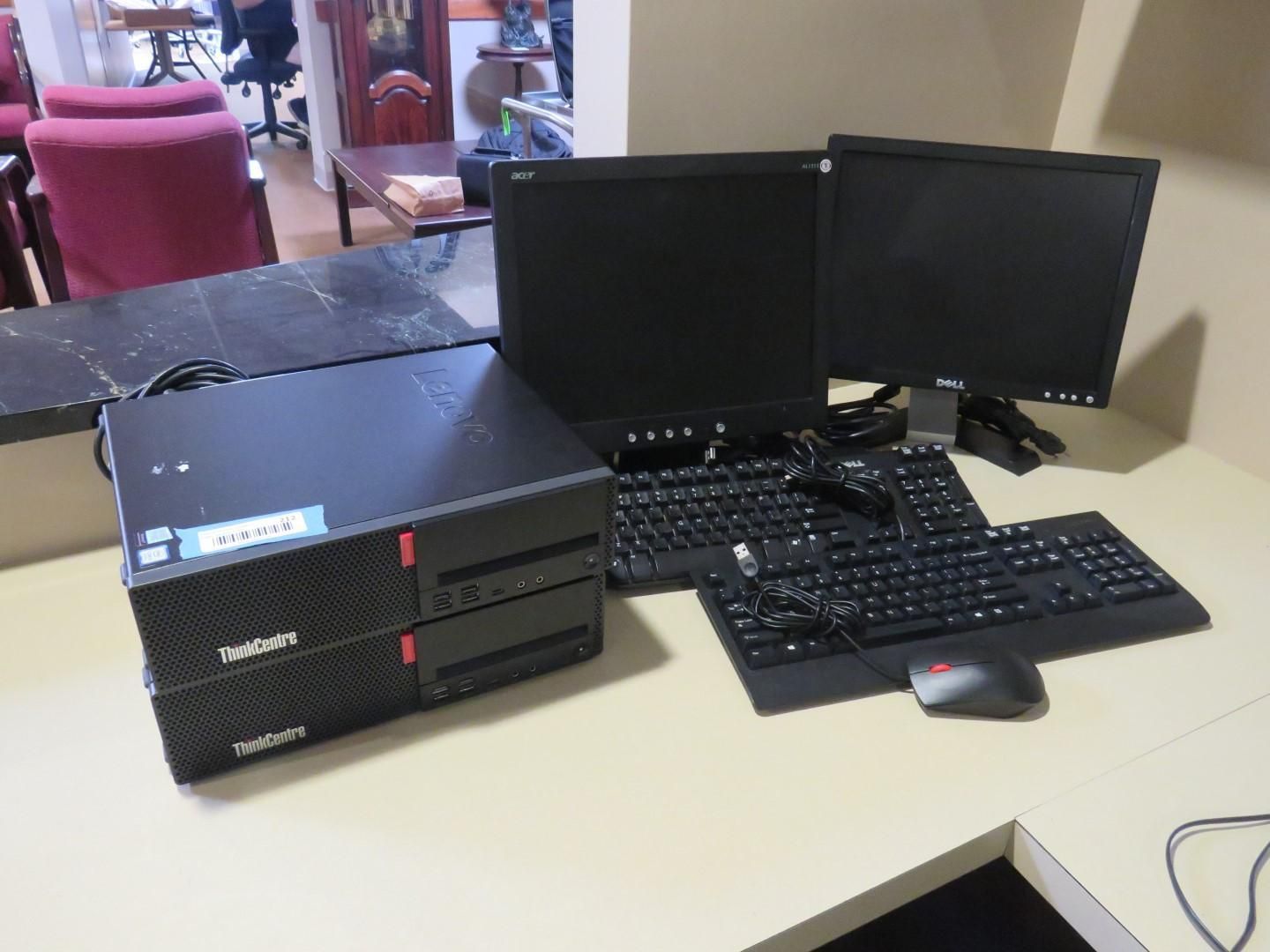 Two ThinkPad computers, two monitors, two keyboards, and a mouse on a desk.
