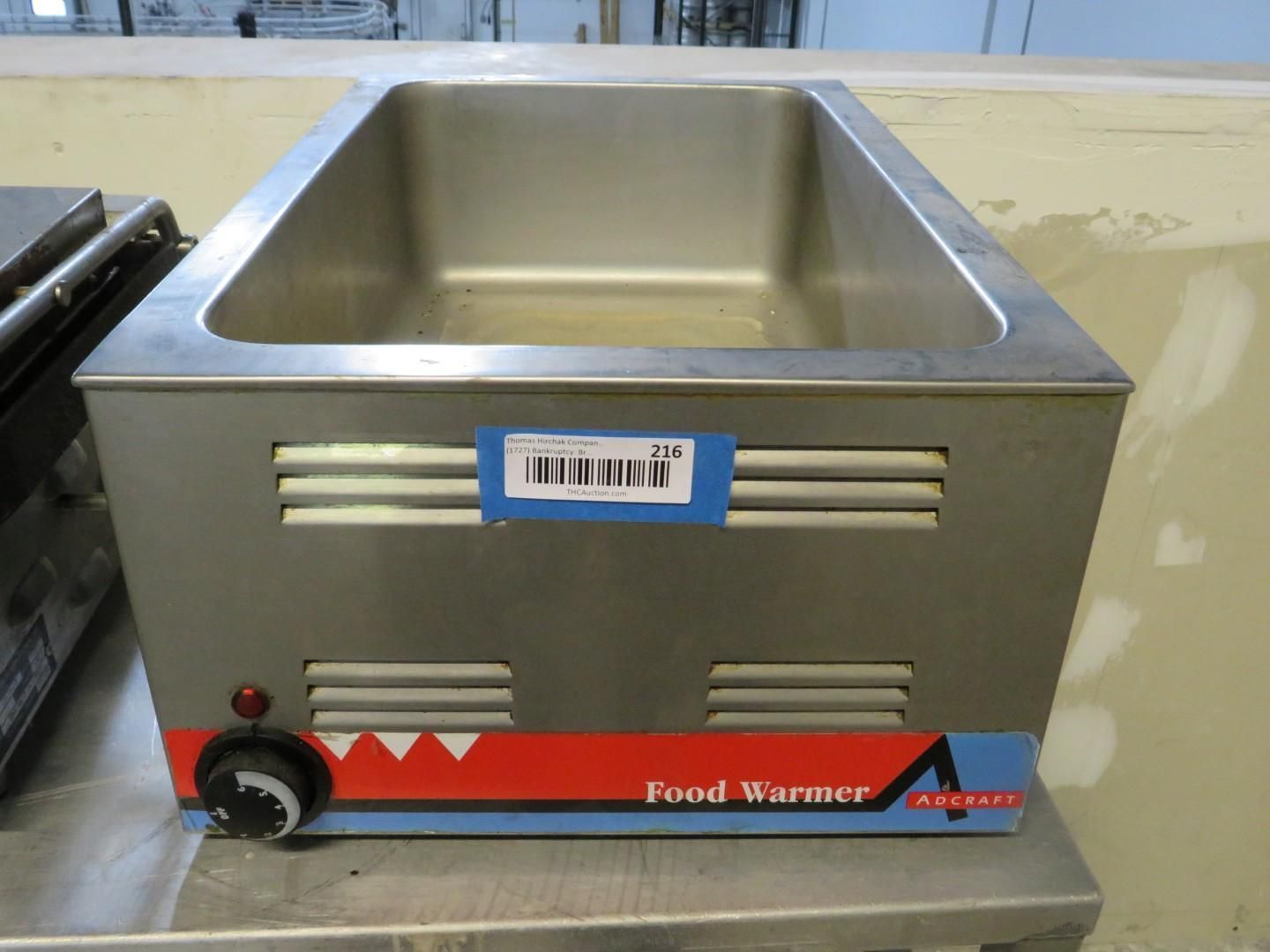 Stainless steel food warmer with temperature dial and vent slots.