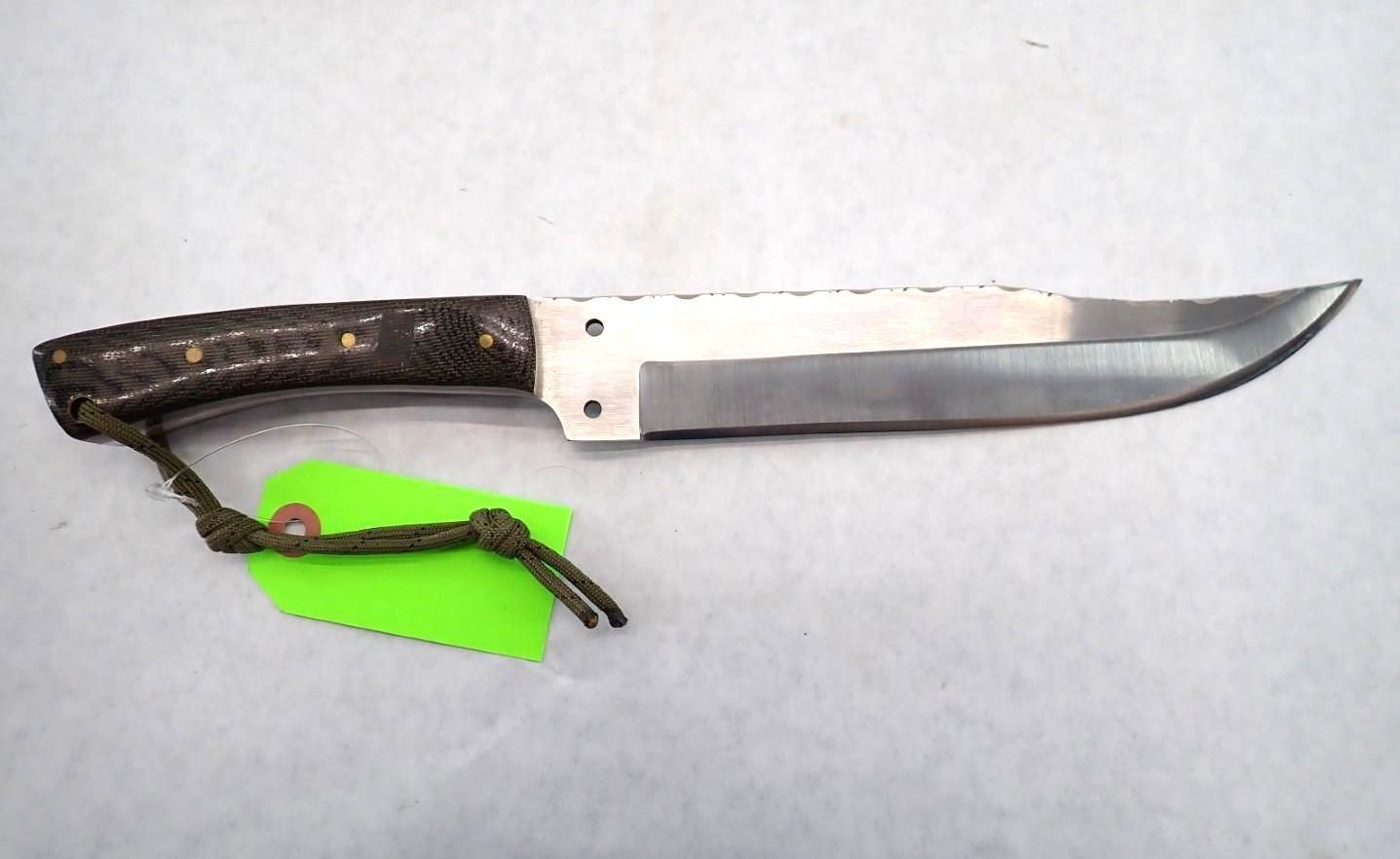 Machete-style knife with dark handle and silver blade