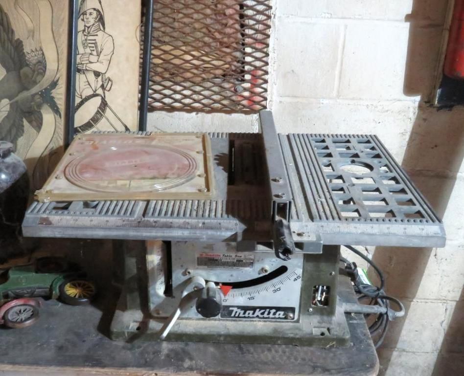 Makita table saw on a workbench; visible blade, fence, and controls.