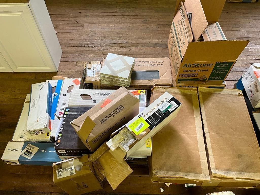 Cardboard boxes and various items piled on a wooden surface.