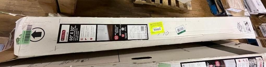 Cardboard box with shipping labels and an arrow indicating direction.