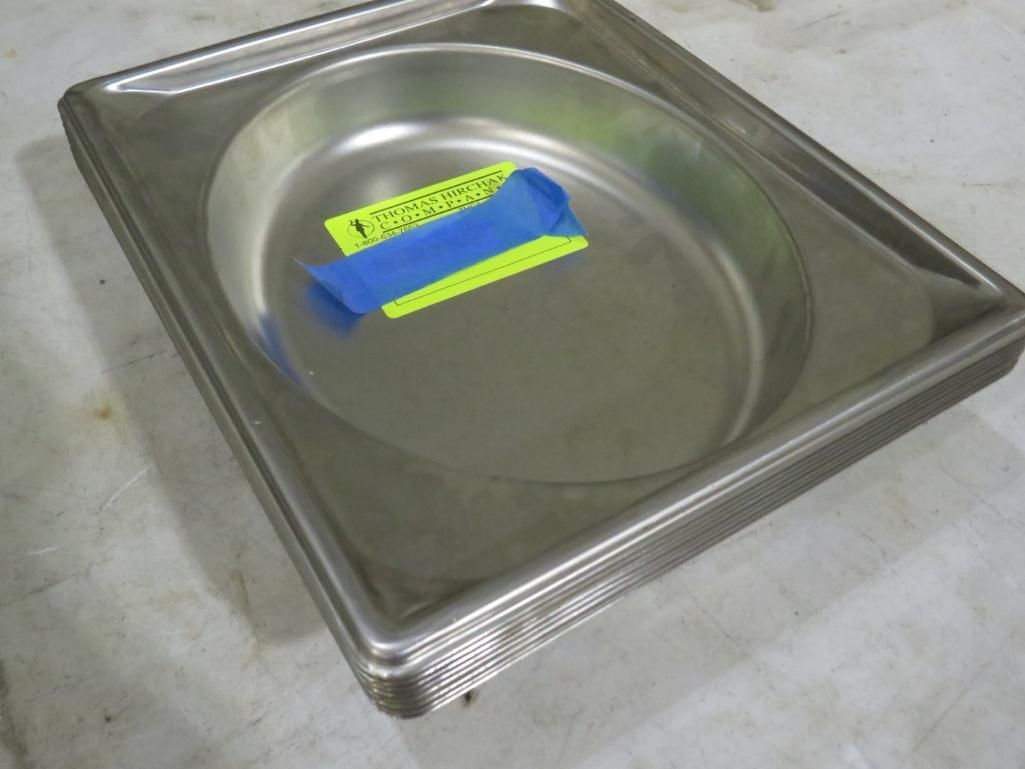 Stainless steel oval basin set inside a rectangular tray, with a blue and yellow sticker.