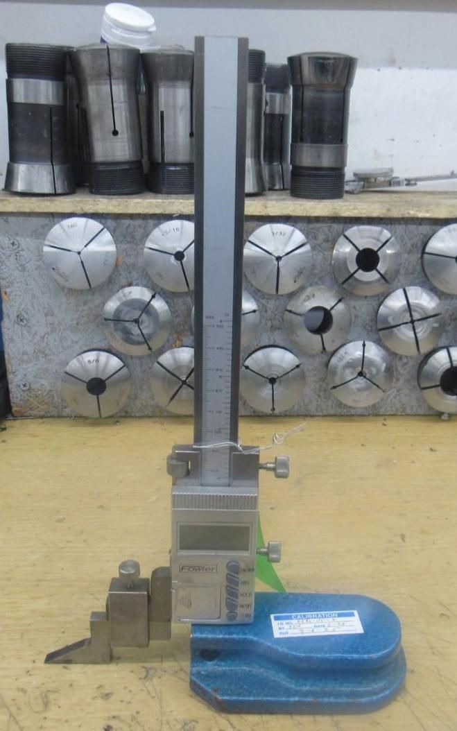 Digital height gauge on a workbench.