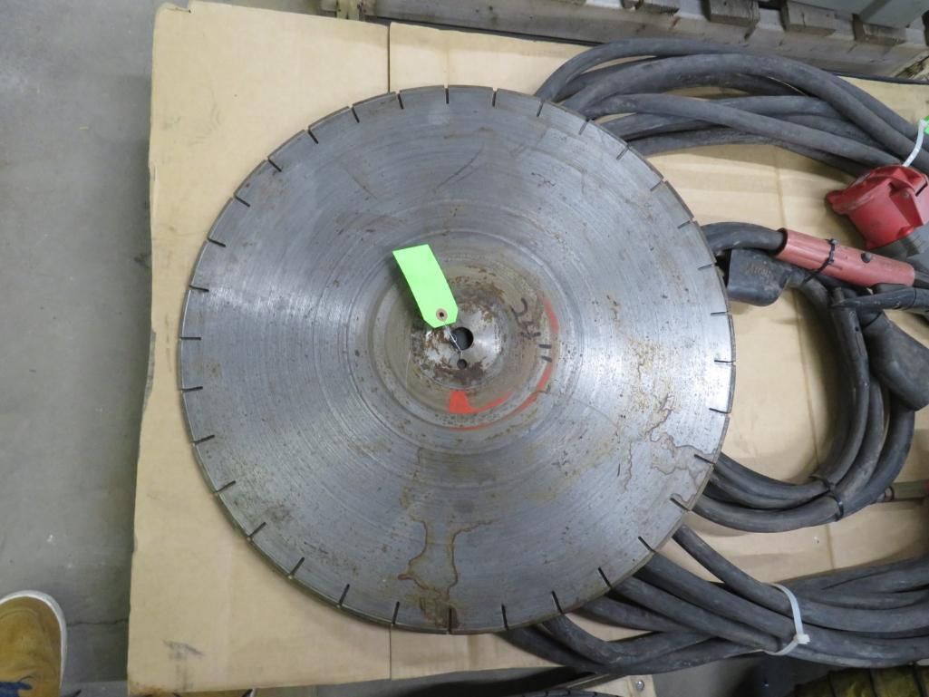 Circular saw blade with a bundle of black electrical cords.