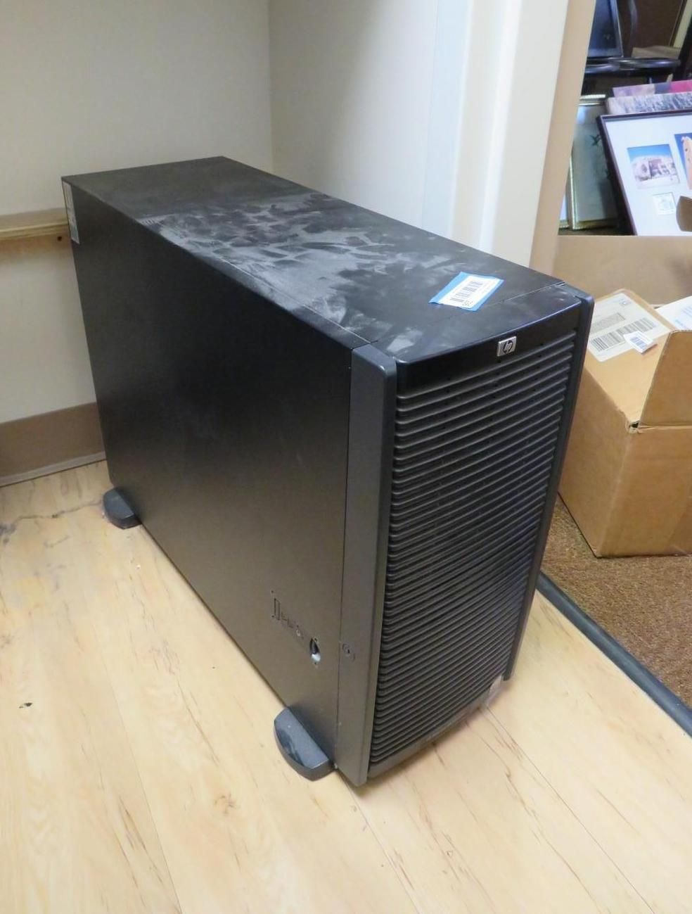 Black HP server on a wood floor.
