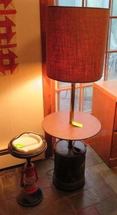 Floor lamp with a reddish shade and a table base next to a red lantern with a tray.