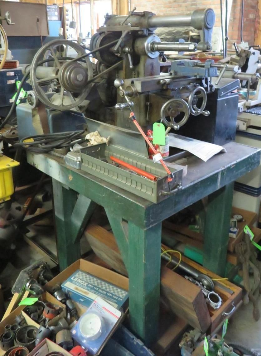 Machinery on a green table in a workshop, with belts and gears visible.