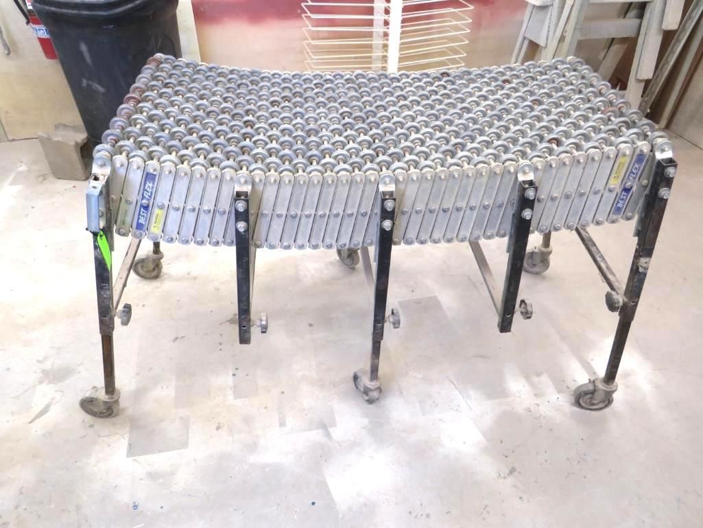 Rolling conveyor belt on a metal frame, in a workshop.