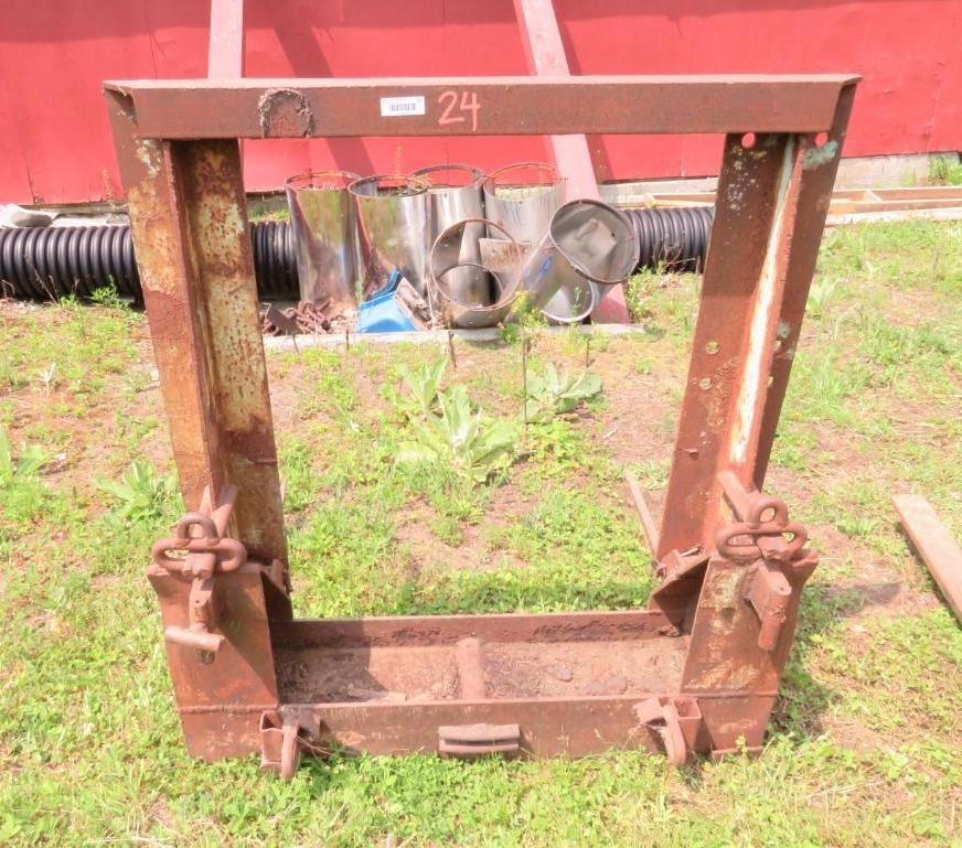 Metal tractor attachment with angled sides, a rectangular base, and brackets for tools.
