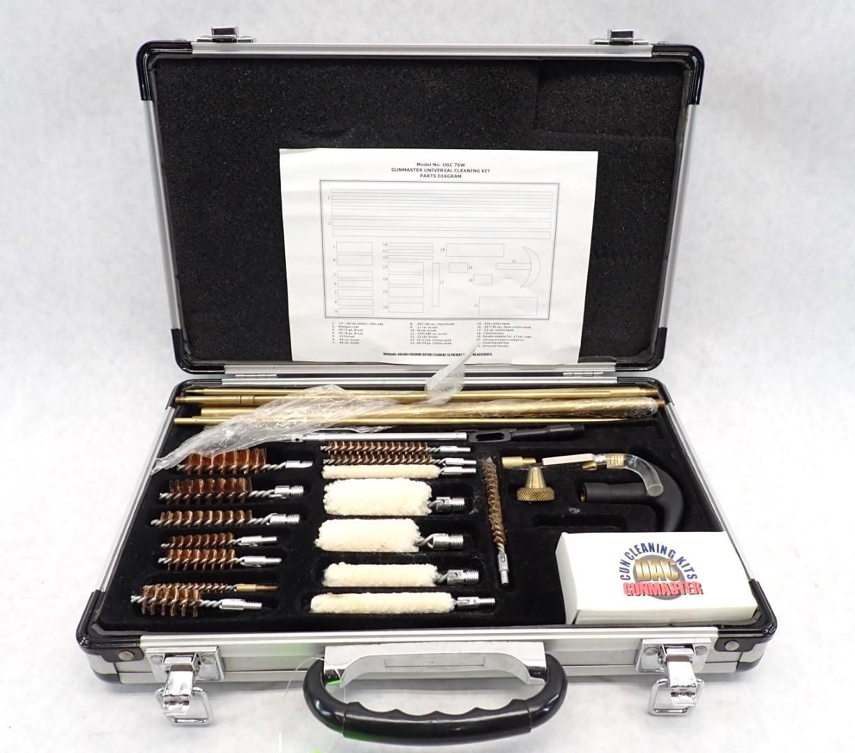 Open gun cleaning kit with various brushes, rods, and supplies in a silver case.