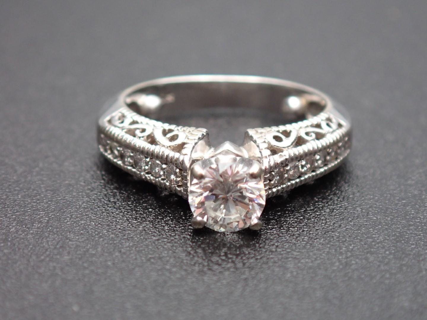 Diamond ring with intricate filigree band.