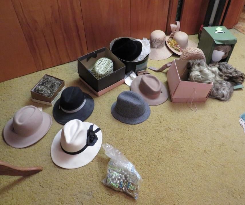 Hats of various colors and styles, some in boxes.