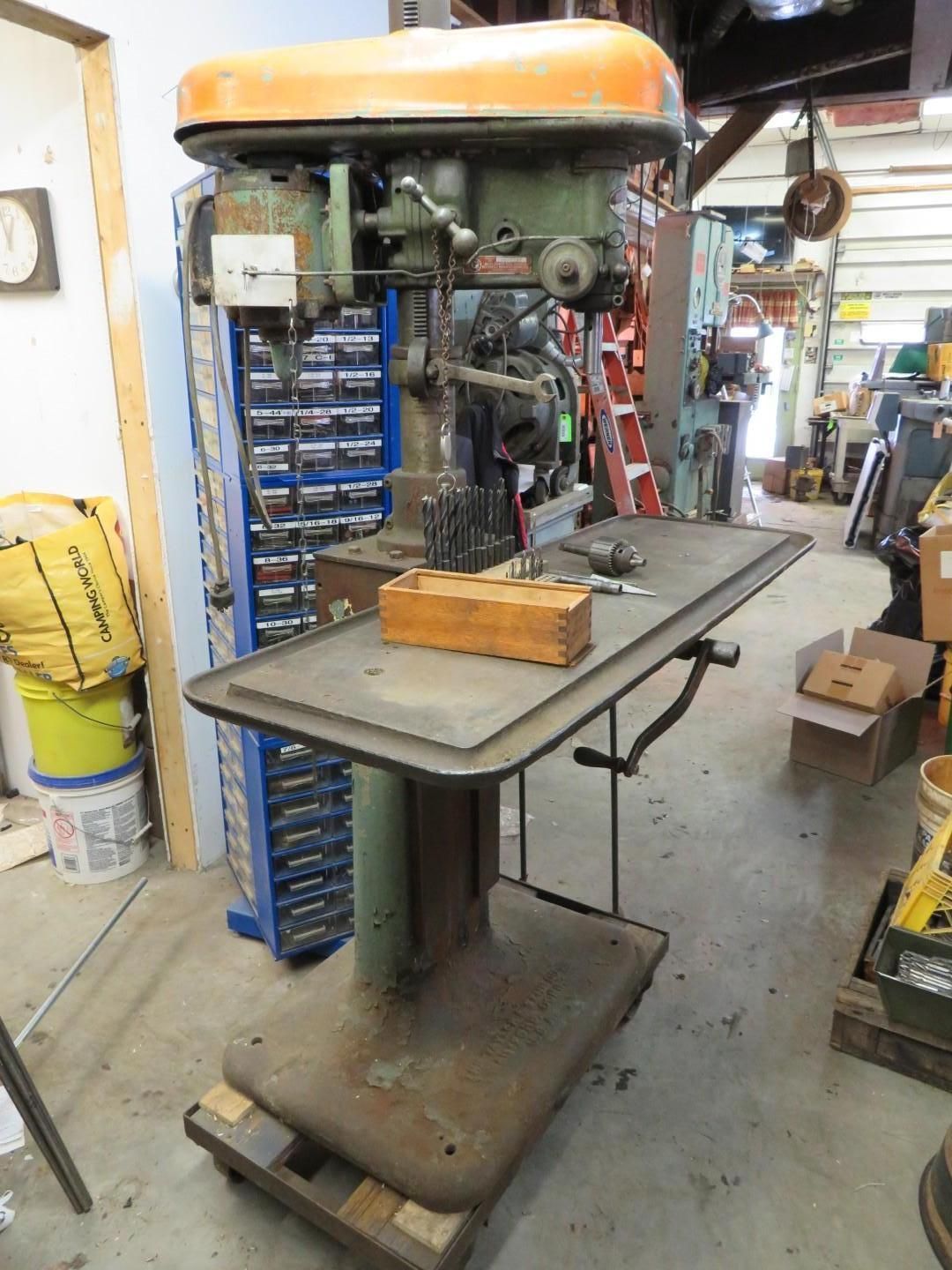 Green and orange industrial drill press.