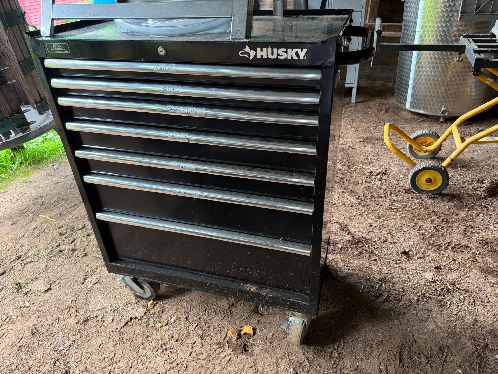 Black Husky tool chest with multiple drawers on wheels.