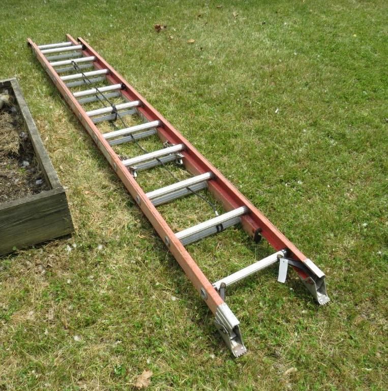 Red and silver extension ladder.