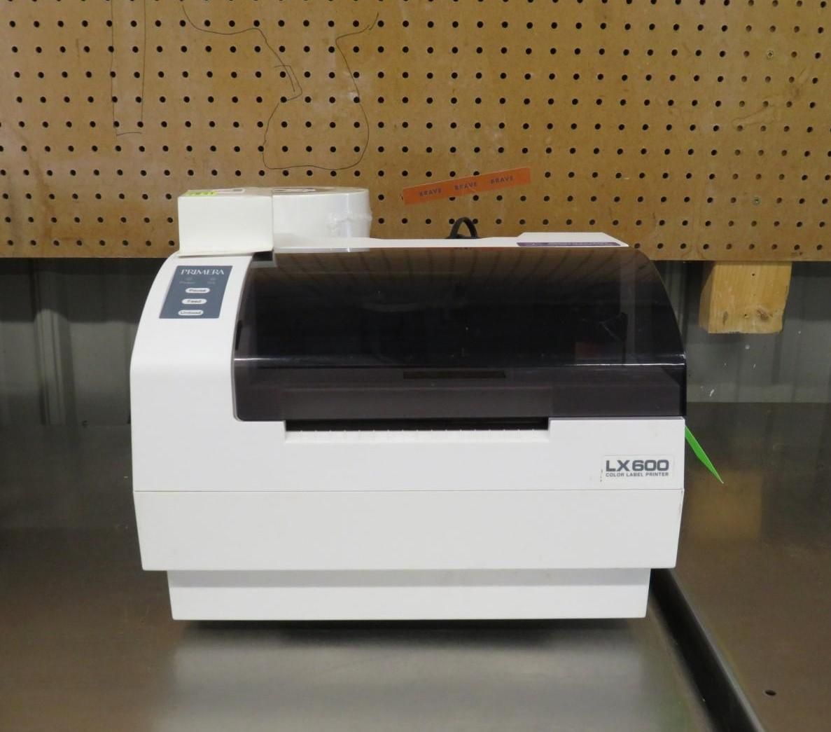 White and black LX800 label printer on a table against a wooden background.