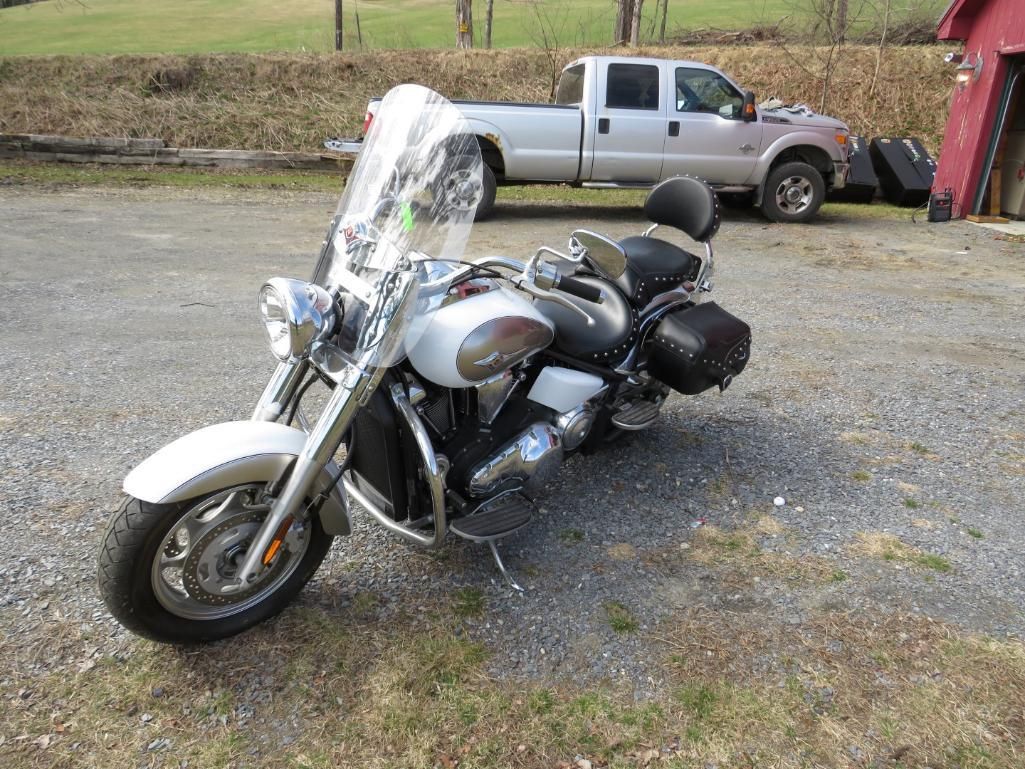 White motorcycle parked on gravel.