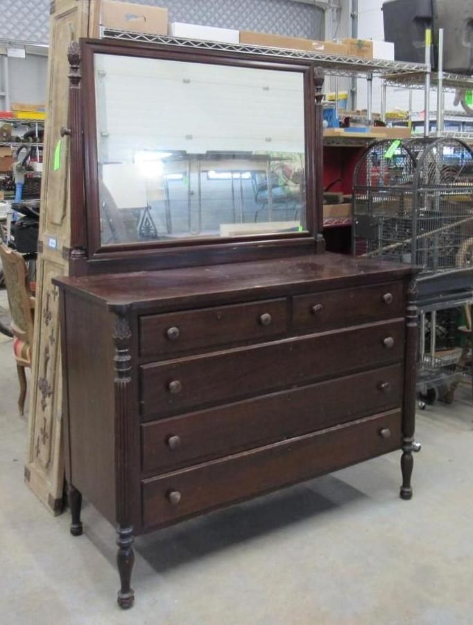 Dark wood dresser with mirror; four drawers, two smaller drawers above.